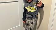 Kaison joined the competition — help win amazing prizes! child, curly_hair, tongue_out, sweatshirt, simpsons, ripped_jeans, sneakers, door, wooden_floor, beige_wall, playful, standing, indoor, person, casual_clothing, happy, young, smiling, hand_gesture, portrait