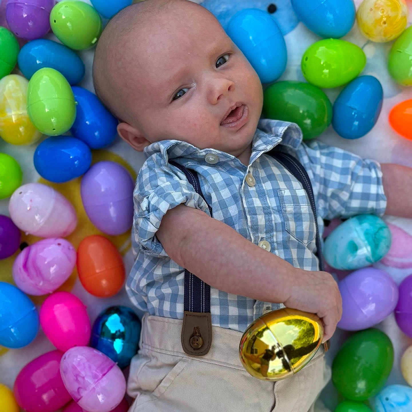 Zayden is registered to the contest to win money with this photo: accessories, baby, balloon, candy, clothing, egg, face, food, formalwear, head, pants, people, person, photography, playarea, portrait, purple, sphere, sweets, tie