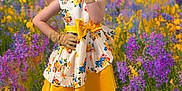 Katie Gardner is registered to the contest to win money with this photo: child, colorful, cute, floral_pattern, flower_field, girl, gloves, grass, headband, nature, outdoor, playful, portrait, smiling, spring, standing, white_shoes, wildflowers, yellow_dress, young_child