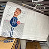 packaging, baby_mattress, inclined_mattress, store_shelf, cardboard_boxes, product_label, sleeping_baby_image, white_mattress, retail_display, price_tag, chicco_box, baby_product, text, plastic_wrapping, shopping, retail, store, product, infant, baby