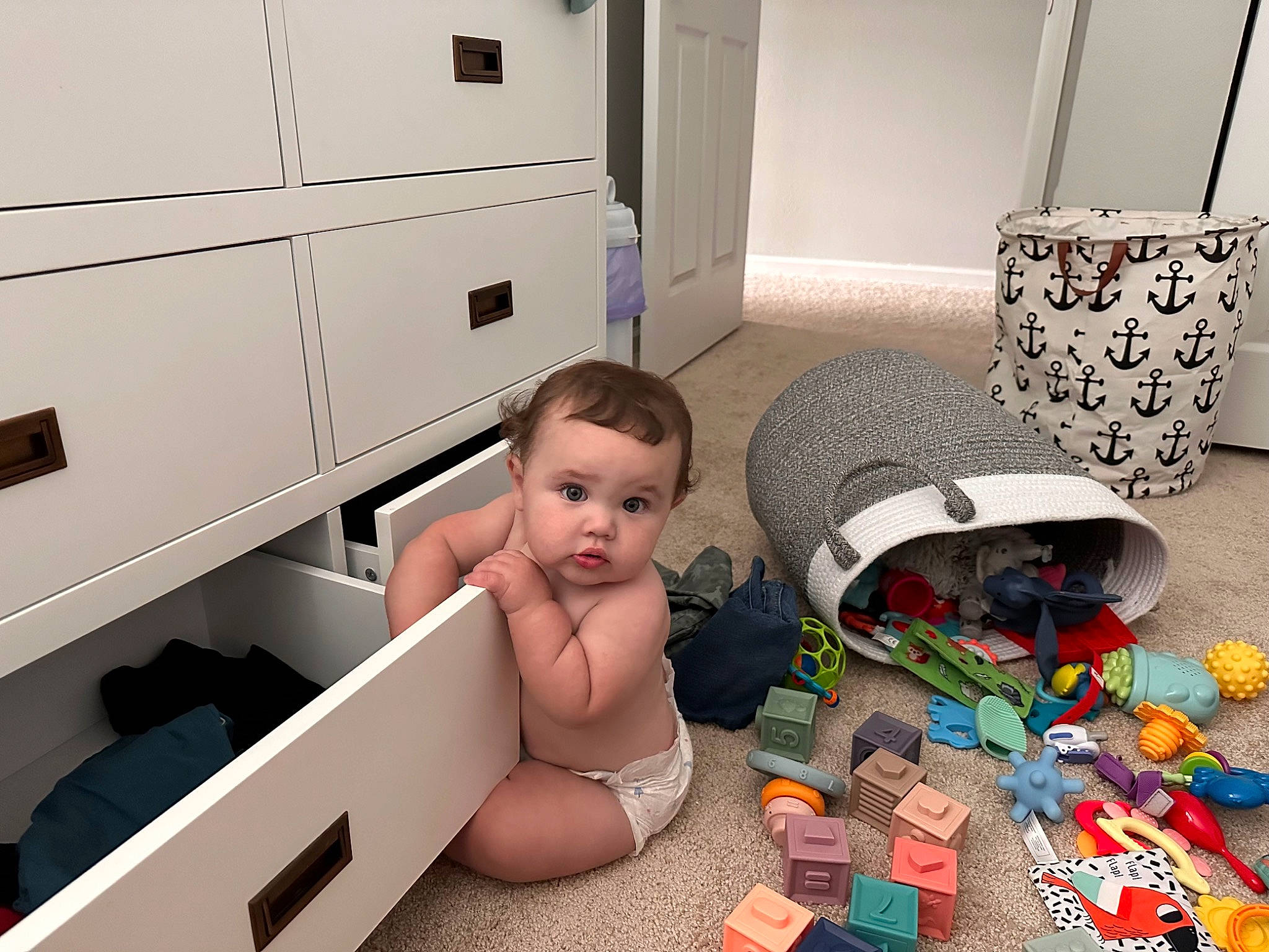 Kylo is registered to the contest to win money with this photo: baby, baby_products, baby_toys, cabinetry, chest_of_drawers, child, comfort, drawer, floor, flooring, home_appliance, house, living_room, machine, person, property, room, stuffed_toy, surprise, toddler