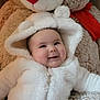 Lily is registered to the contest to win money with this photo: baby, blanket, bonnet, clothing, coat, couch, cushion, face, furniture, happy, hat, head, homedecor, newborn, person, photography, portrait, smile, teddybear, toy