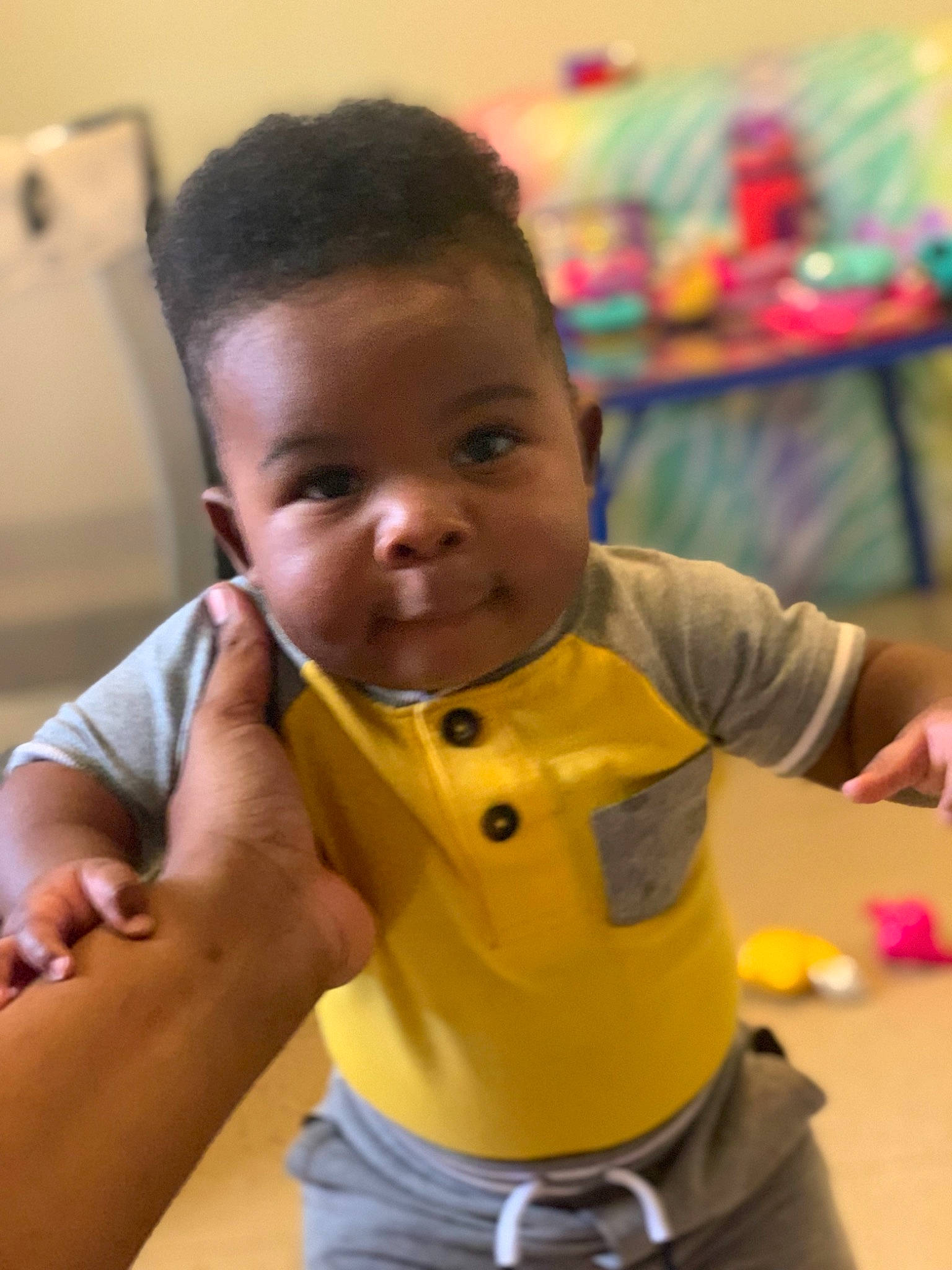 Deshawn is registered to the contest to win money with this photo: baby, child, neck, person, play, toddler, yellow