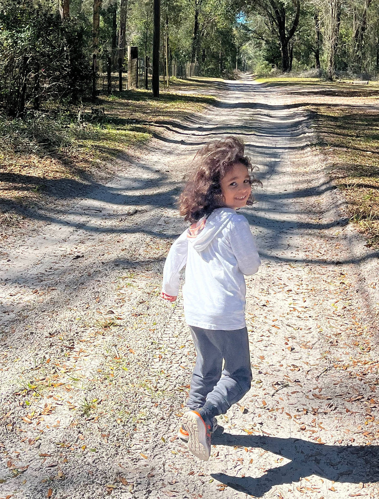 Israel is registered to the contest to win money with this photo: asphalt, branch, gesture, grass, happy, joy, landscape, leaf, leisure, mammal, natural_landscape, people_in_nature, person, plant, recreation, road_surface, standing, sunlight, tints_and_shades, tree