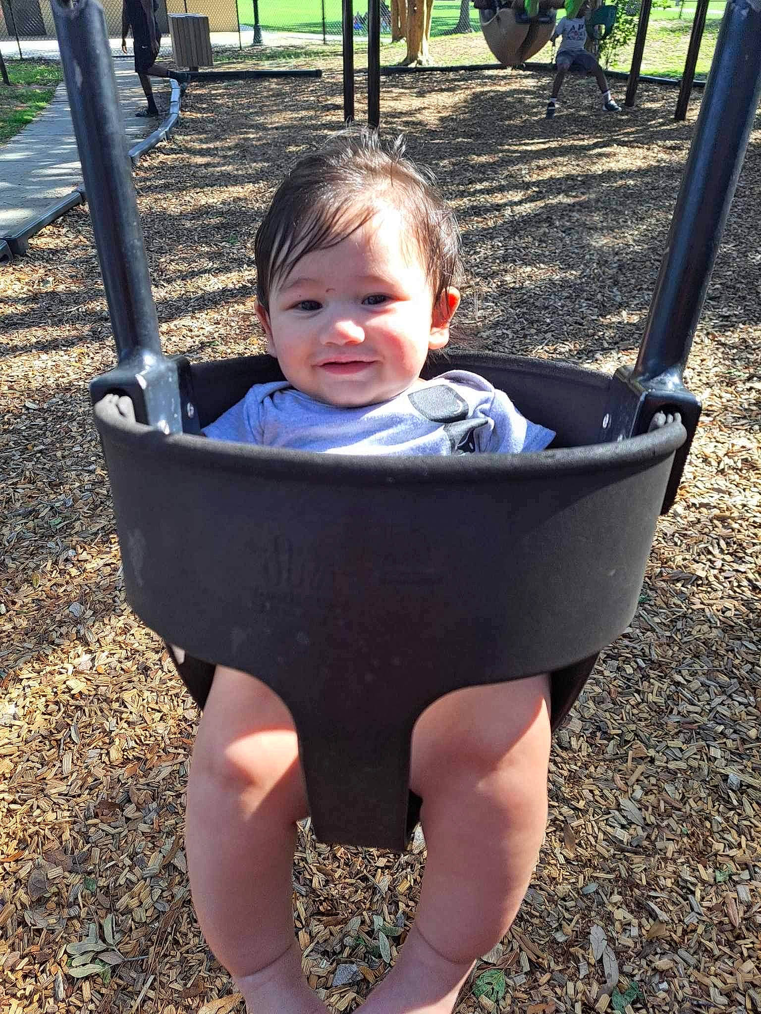 Elijah is registered to the contest to win money with this photo: baby, black, child, eye, facial_expression, grass, green, happy, joy, leisure, people, people_in_nature, person, photograph, playground, public_space, smile, snapshot, toddler, tree