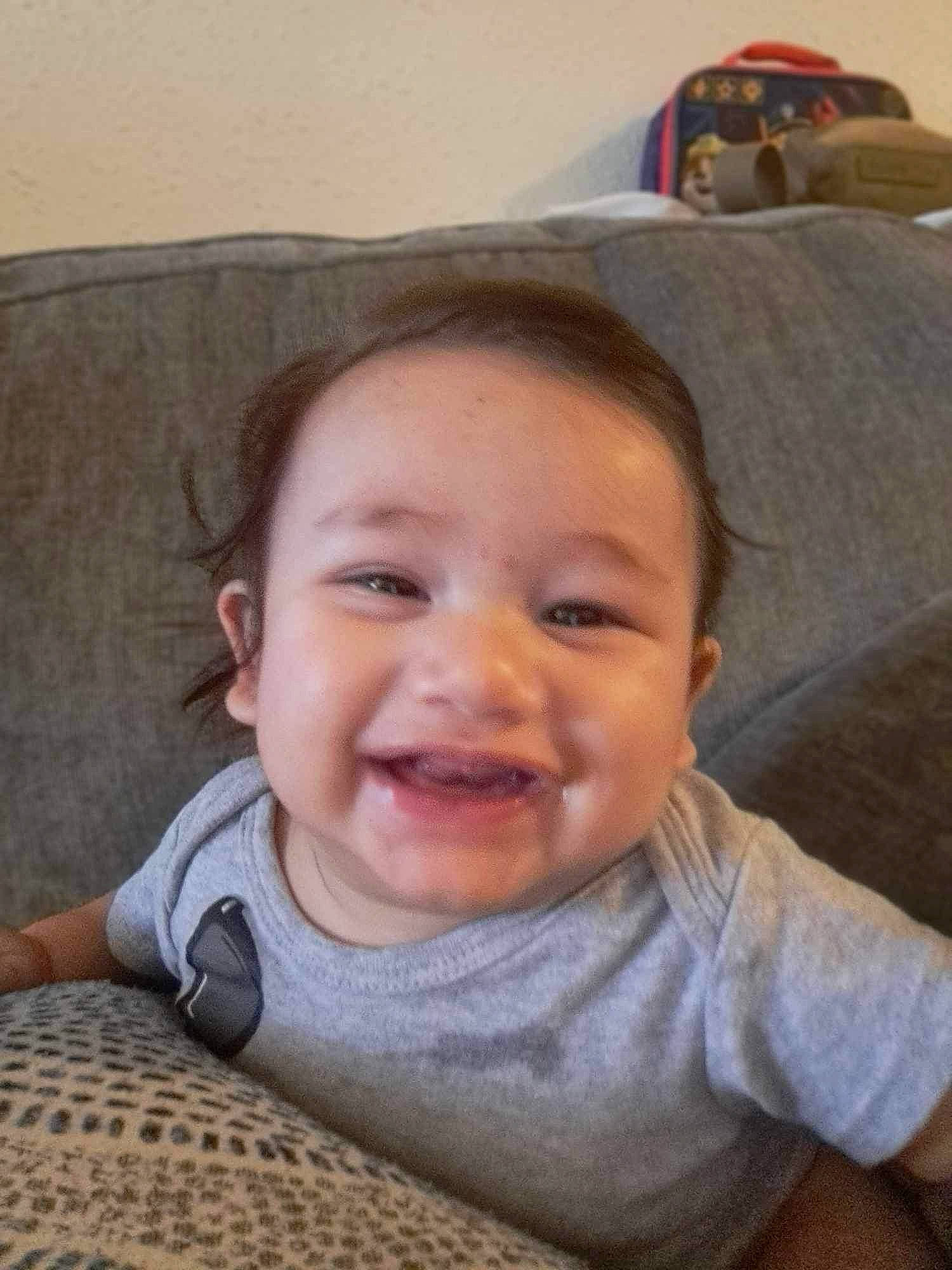 Elijah is registered to the contest to win money with this photo: baby, baby_laughing, baby_toddler_clothing, cheek, child, chin, comfort, couch, fun, happy, head, iris, joy, lip, mouth, nose, person, skin, sleeve, smile