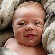 Isaac is registered to the contest to win money with this photo: baby, infant, smiling, face, blanket, soft, cozy, skin, closeup, cute, child, newborn, warm, expression, portrait, young, wrapped, happy, comfort, indoors