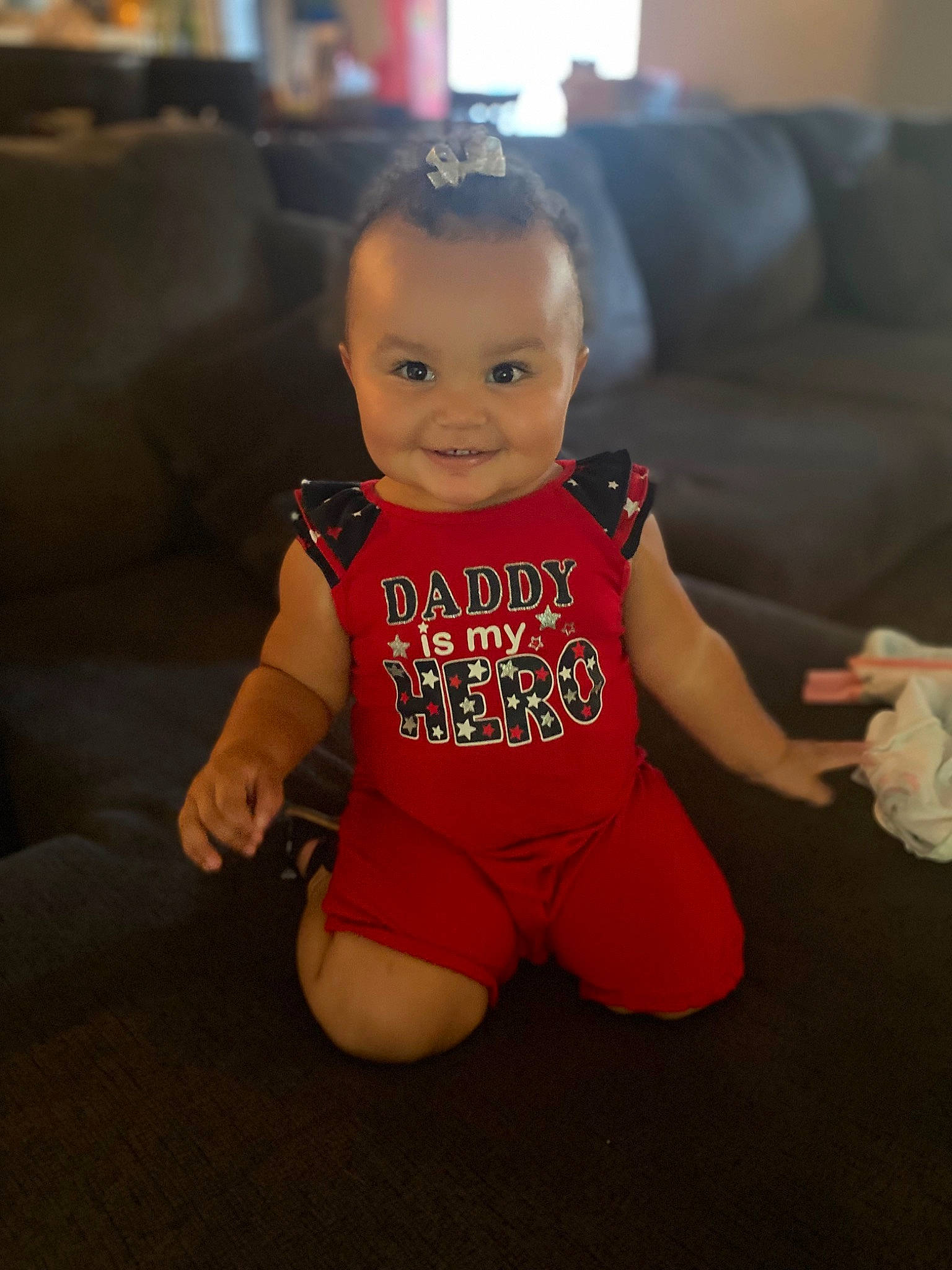 Lillie is registered to the contest to win money with this photo: baby, baby_toddler_clothing, cheek, comfort, couch, eye, face, facial_expression, finger, floor, flooring, happy, head, joy, knee, person, picture_frame, skin, sleeve, smile