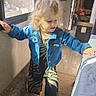 toddler, child, denim_jacket, curly_hair, indoor, carpet, footwear, window, natural_light, camper, rv, bed, balance, step, person, clothing, floor, handrail, interior, young_child