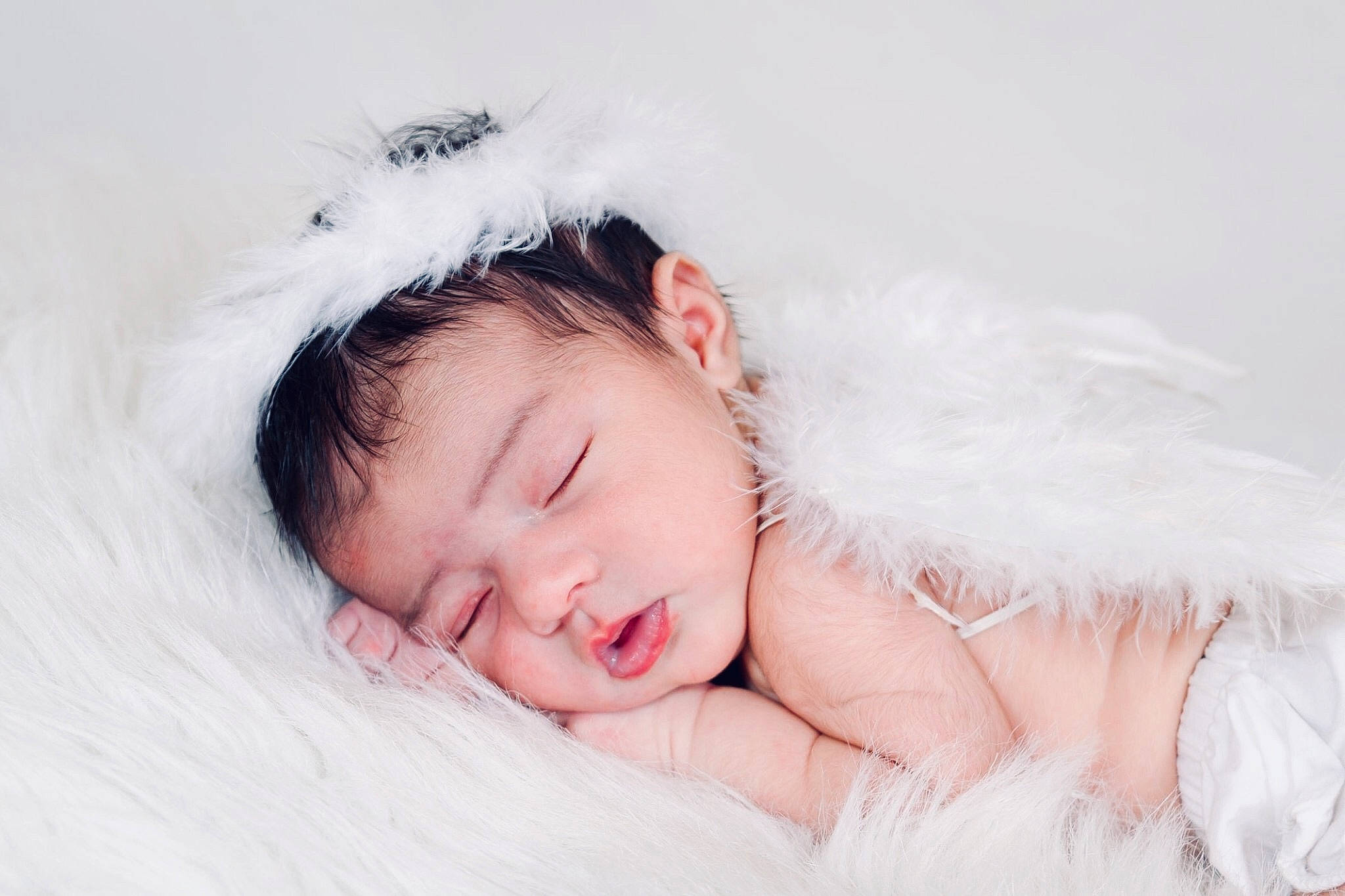 Elia is registered to the contest to win money with this photo: baby, beauty, cheek, child, eye, face, fur, hair_accessory, head, headgear, headpiece, lip, nose, person, photograph, photography, pink, skin, sleep, toddler