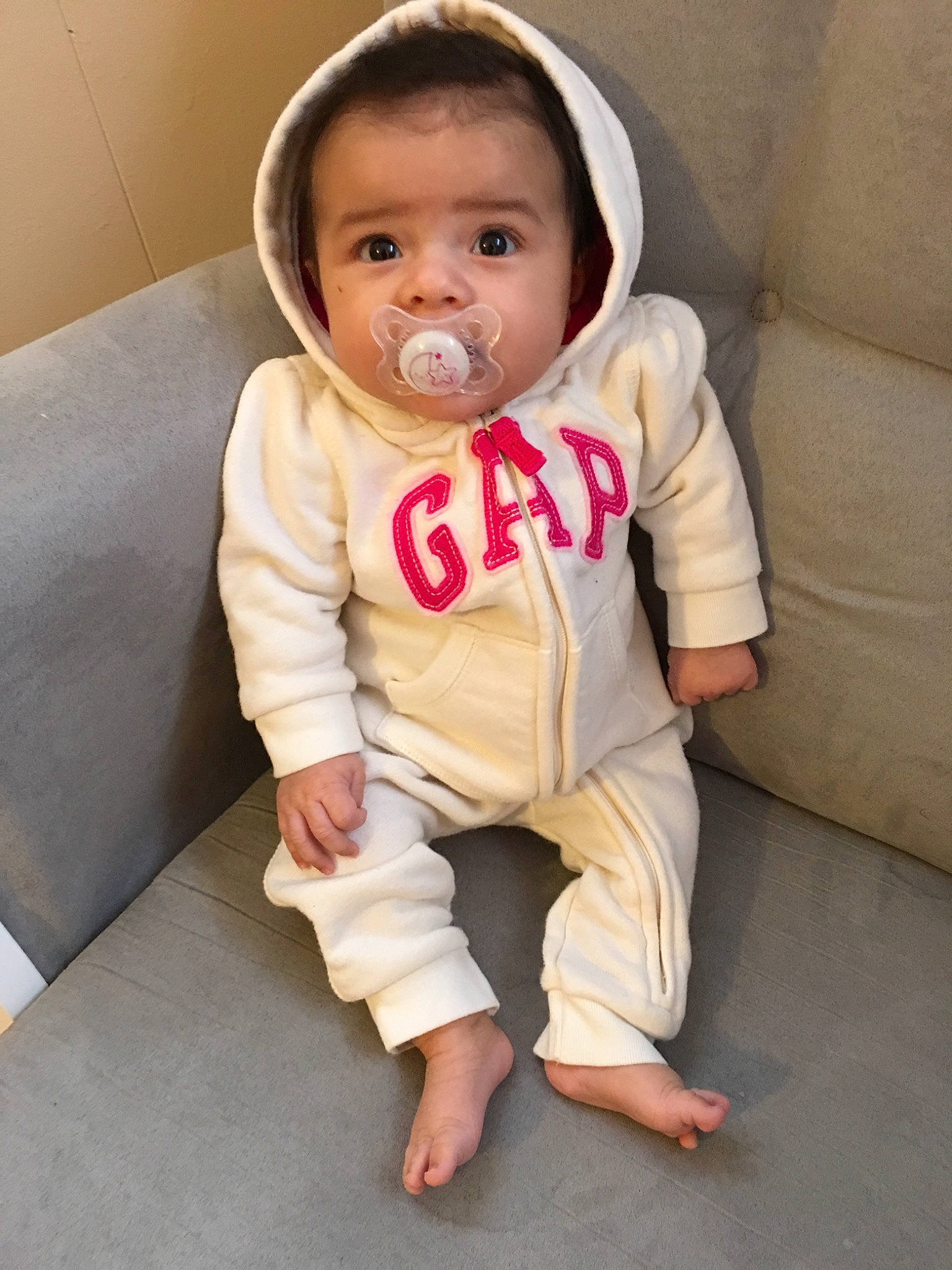 Elia is registered to the contest to win money with this photo: baby, baby_toddler_clothing, cheek, child, outerwear, person, sitting, skin, sleeve, smile, toddler