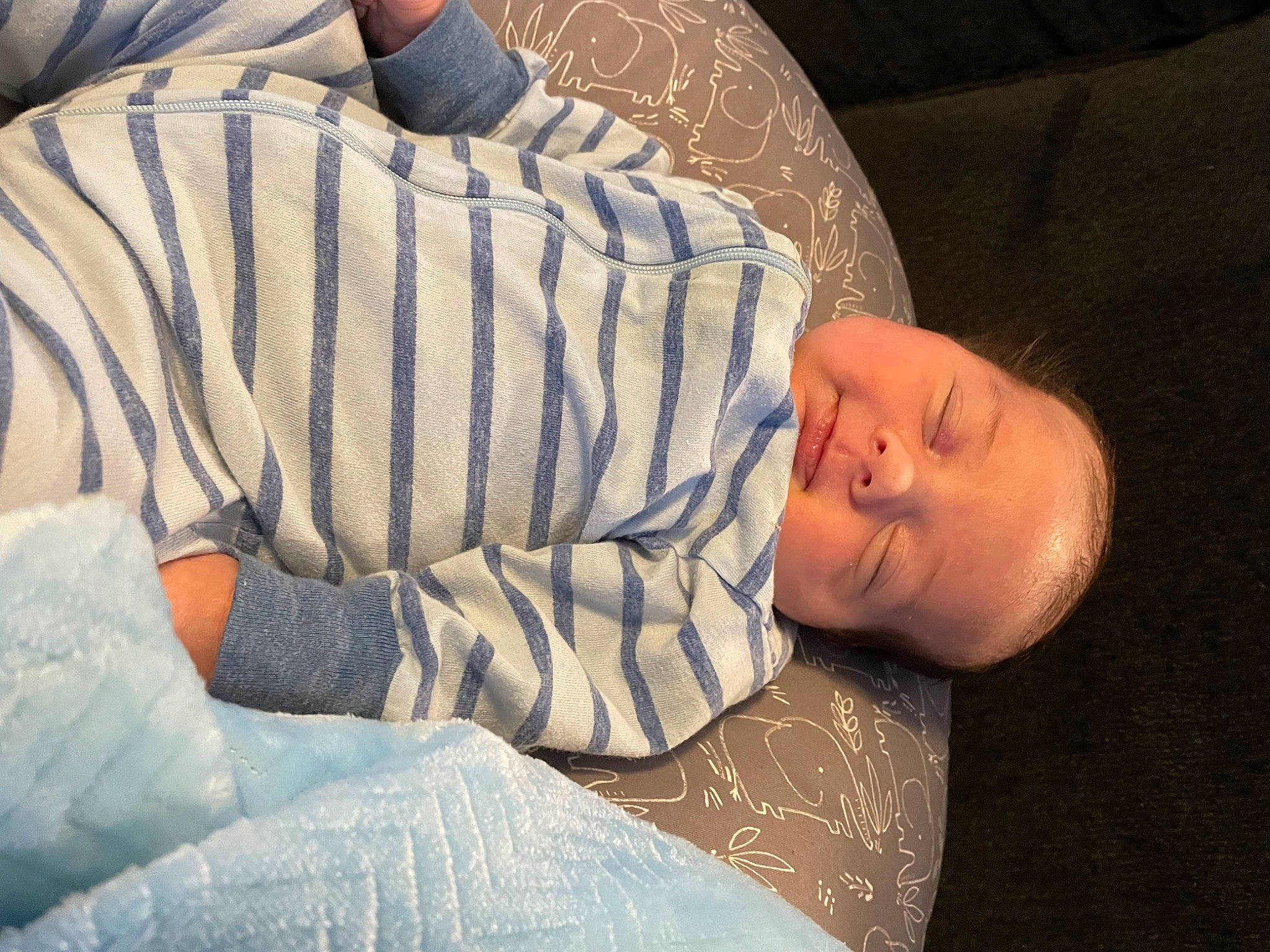 Micah is registered to the contest to win money with this photo: arm, baby, baby_sleeping, baby_toddler_clothing, bedtime, cheek, child, comfort, couch, elbow, flooring, headgear, linens, nap, pattern, person, sitting, skin, sleeve, toddler