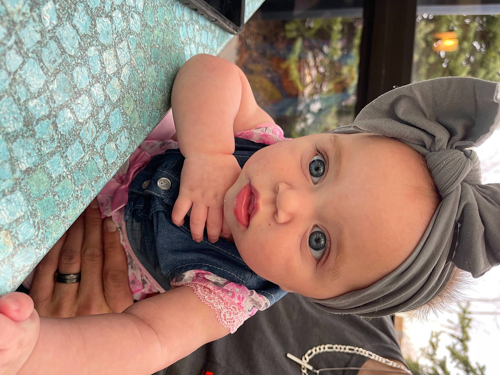 Serenity is registered to the contest to win money with this photo: baby, black_hair, dress, eye, eyelash, face, finger, flash_photography, hand, happy, hat, headwear, human_body, iris, lip, mouth, nose, person, plant, skin