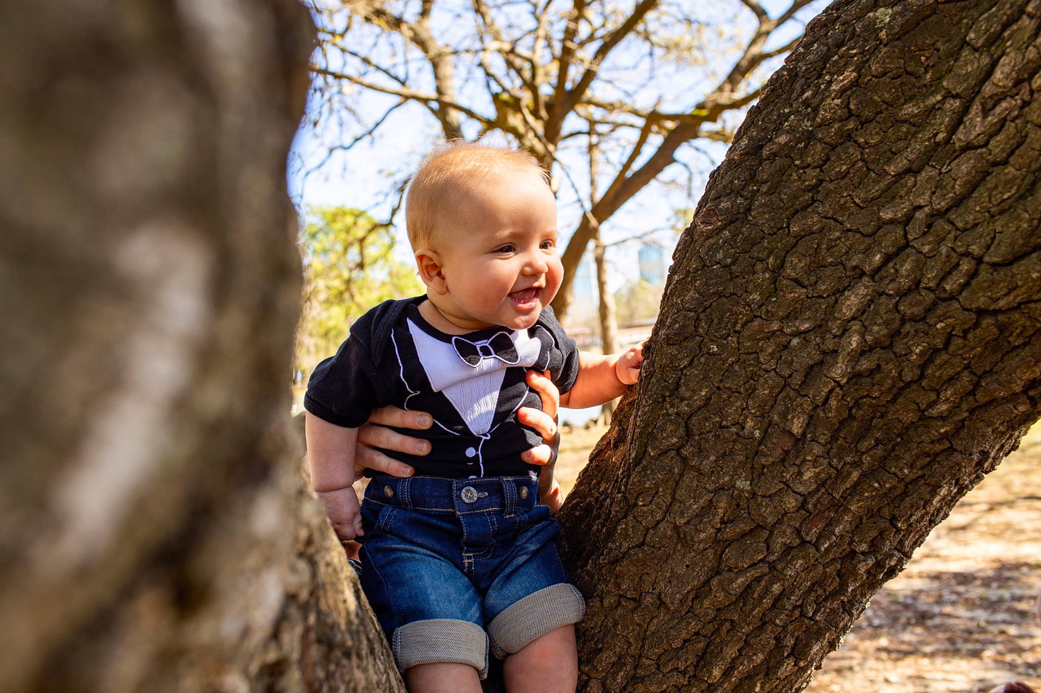 Jiraiya is registered to the contest to win money with this photo: baby, branch, child, child_model, jeans, people_in_nature, person, photo_shoot, photograph, photography, plant, play, portrait, portrait_photography, smile, toddler, tree, trunk, wood, woody_plant