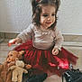 Tessa a rejoint le concours — aidez-le/la à gagner de superbes lots ! toddler, child, girl, red_skirt, black_boots, pigtails, red_ribbons, stuffed_toys, doll, floor, tile_floor, wall, indoor, cute, smiling, playful, sitting, long_sleeve_shirt, home, childhood