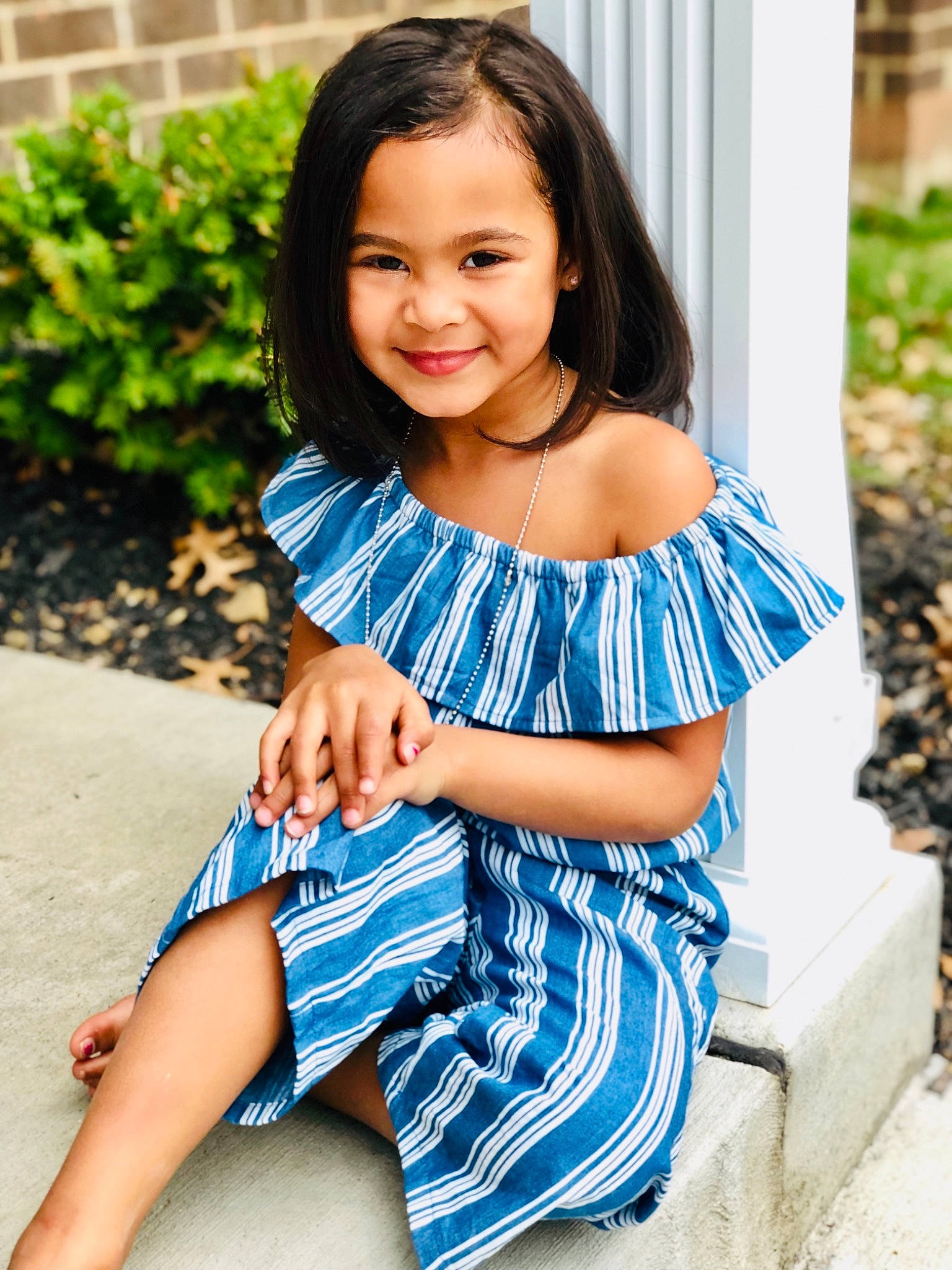 Raina is registered to the contest to win money with this photo: beauty, blue, child, child_model, clothing, dress, joint, joy, leg, pattern, person, photo_shoot, photography, shoulder, sitting, sleeve, smile, textile, thigh, toddler
