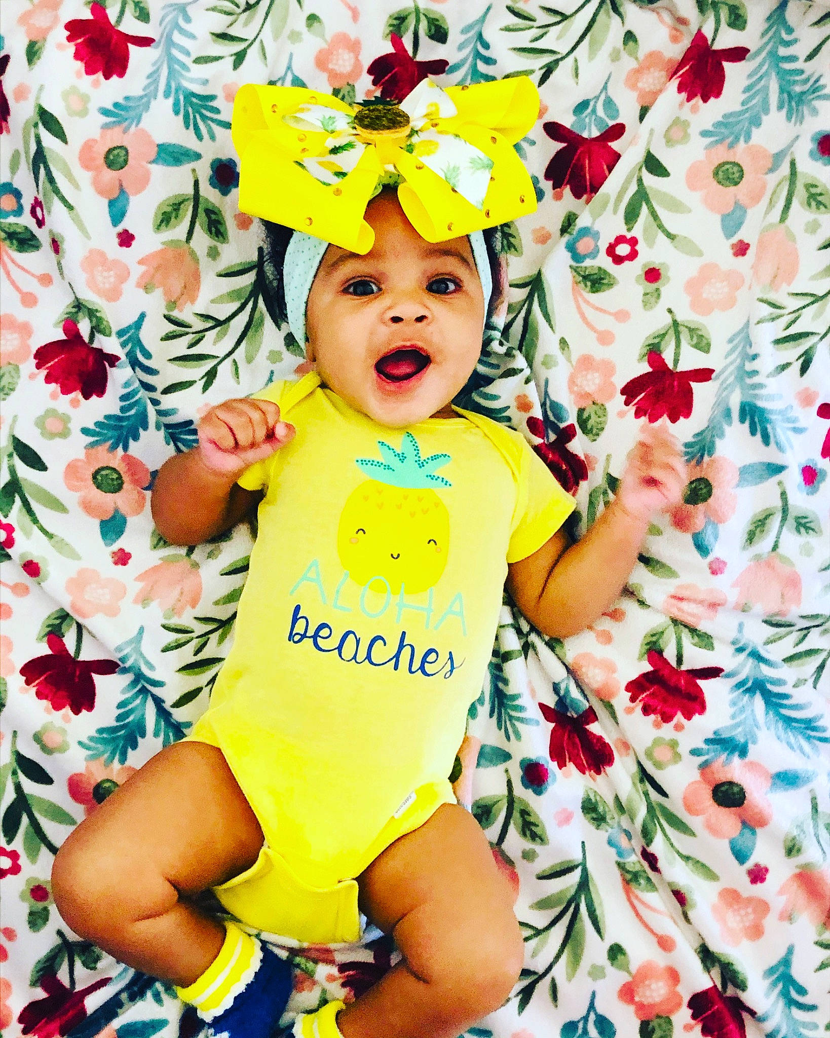 Zamaya is registered to the contest to win money with this photo: baby, baby_toddler_clothing, child, clothing, face, flower, font, fun, happy, hat, headwear, pattern, people_in_nature, person, petal, pink, product, sleeve, t_shirt, textile