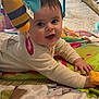baby, baby_gym, child, clothing, colorful, crawling, cute, fabric, face, floor, happy, indoor, infant, pattern, person, play_mat, playtime, smiling, soft_toy, toy