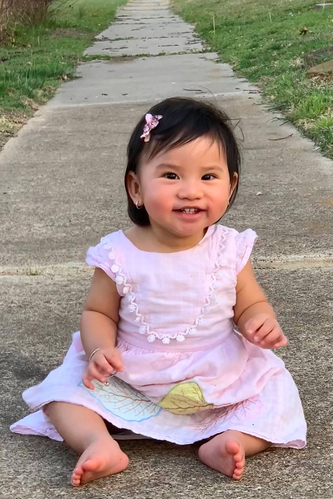 Sofia is registered to the contest to win money with this photo: baby, baby_toddler_clothing, barefoot, cheek, child, dress, eye, foot, fun, grass, hair, happy, joy, person, pink, plant, recreation, skin, sleeve, smile