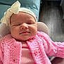 Freya is registered to the contest to win money with this photo: baby, infant, sleeping, pink_clothing, knitted_sweater, headband, bow, face, closed_eyes, chair, cozy, indoor, person, newborn, cute, soft_texture, relaxing, comfort, child, peaceful
