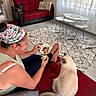 şişko participe au concours pour gagner de l'argent avec cette photo : woman, cat, couch, red_couch, headband, coffee_cup, indoor, carpet, table, window, curtains, floor, relaxing, pet, furniture, home, casual, seated, cozy, light