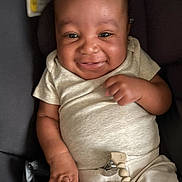 Wave is registered to the contest to win money with this photo: baby, baby_boy, car_seat, child, child_safety, clothing, cute, happy, human, indoors, infant, light_clothes, pacifier_clip, person, portrait, seat, seatbelt, sitting, smiling, young_child