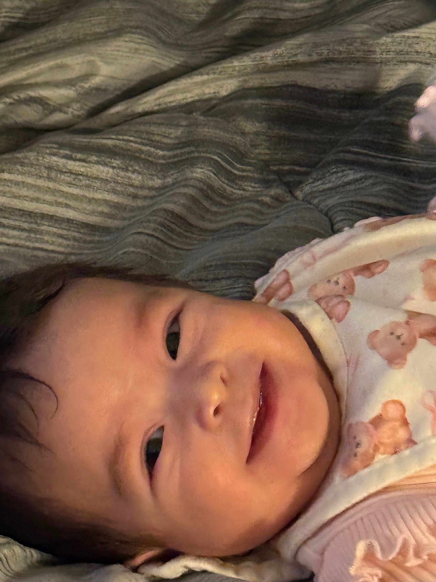 Maryory joined the competition — help win amazing prizes! baby, smiling, face, infant, blanket, bib, teddy_bear_pattern, closeup, child, cute, young, portrait, lying_down, soft_lighting, indoors, warm_colors, happy, baby_clothes, skin, person