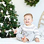 bed, blue_eyes, child, christmas_tree, cozy, cute, decorations, festive, happy, holiday_decor, holiday_lighting, home, indoor, portrait, seasonal, smile, striped_sweater, toddler, white_bedspread, wreath