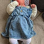 baby, infant, child, denim_dress, headband, flower, tights, socks, cushion, blanket, soft_fabric, indoor, laying_down, cute, small_hands, face, person, resting, comfort, cozy