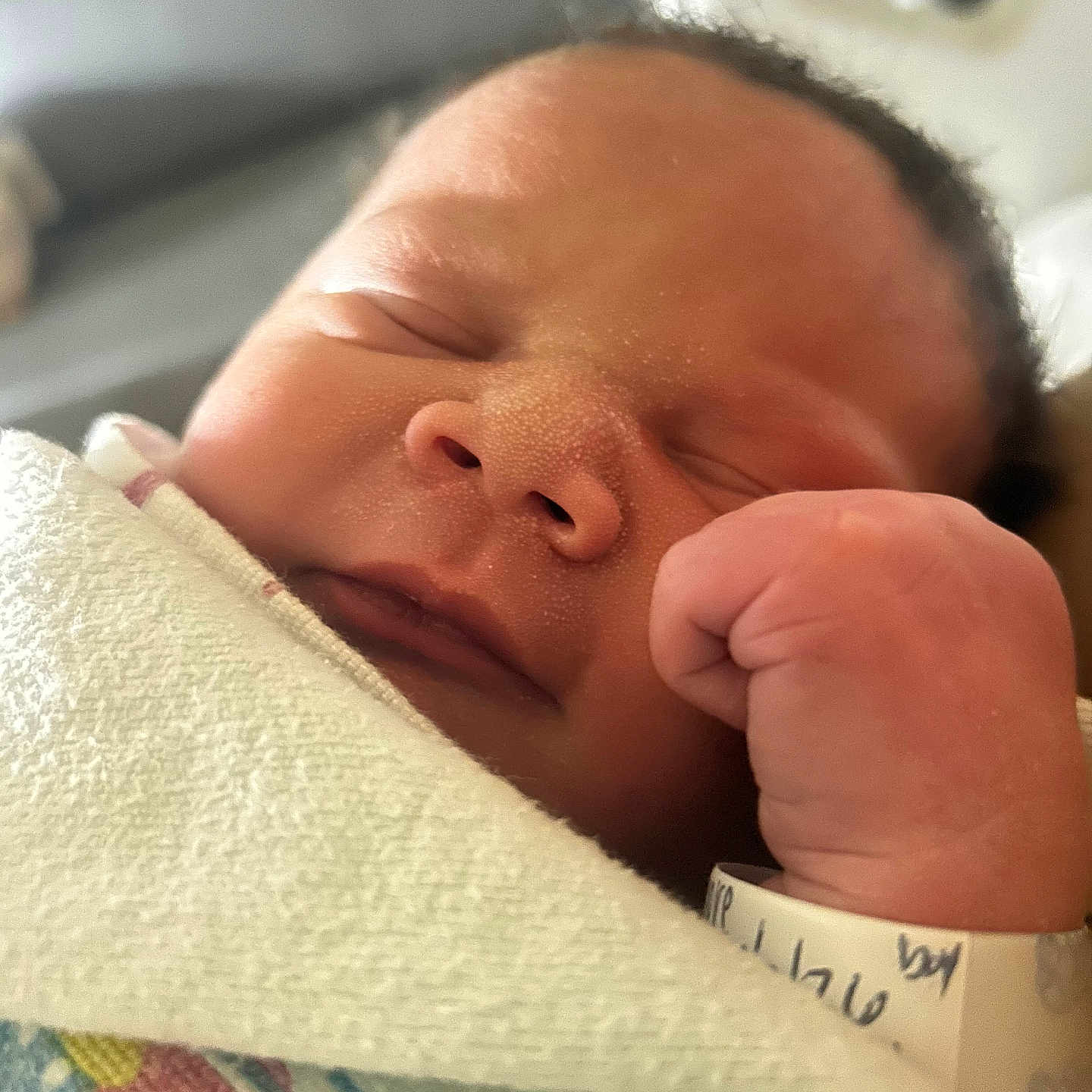 Elias is registered to the contest to win money with this photo: newborn, baby, sleeping, infant, wrapped, blanket, hospital, wristband, hand, face, peaceful, closeup, skin, cute, small, soft, resting, indoors, person, portrait