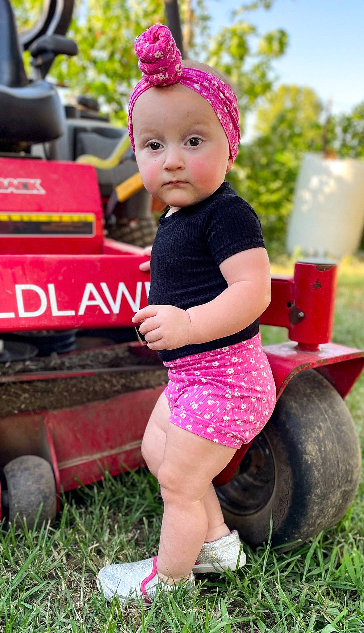 Marley joined the competition — help win amazing prizes! automotive_tire, baby, baby_toddler_clothing, cap, child, facial_expression, fun, grass, happy, hat, human_leg, leisure, magenta, people_in_nature, person, pink, red, shorts, tire, toddler