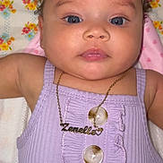 Zenelle is registered to the contest to win money with this photo: baby, child, face, portrait, blue_eyes, headband, bow, necklace, jewelry, purple_outfit, buttons, butterfly_pattern, clothing, infant, cute, closeup, skin, person, laying_down, adorable