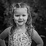 child, girl, portrait, black_and_white, smile, dress, flower_pattern, long_hair, confident, outdoor, nature, face, happy, posing, young, person, photography, cute, hair, eyes