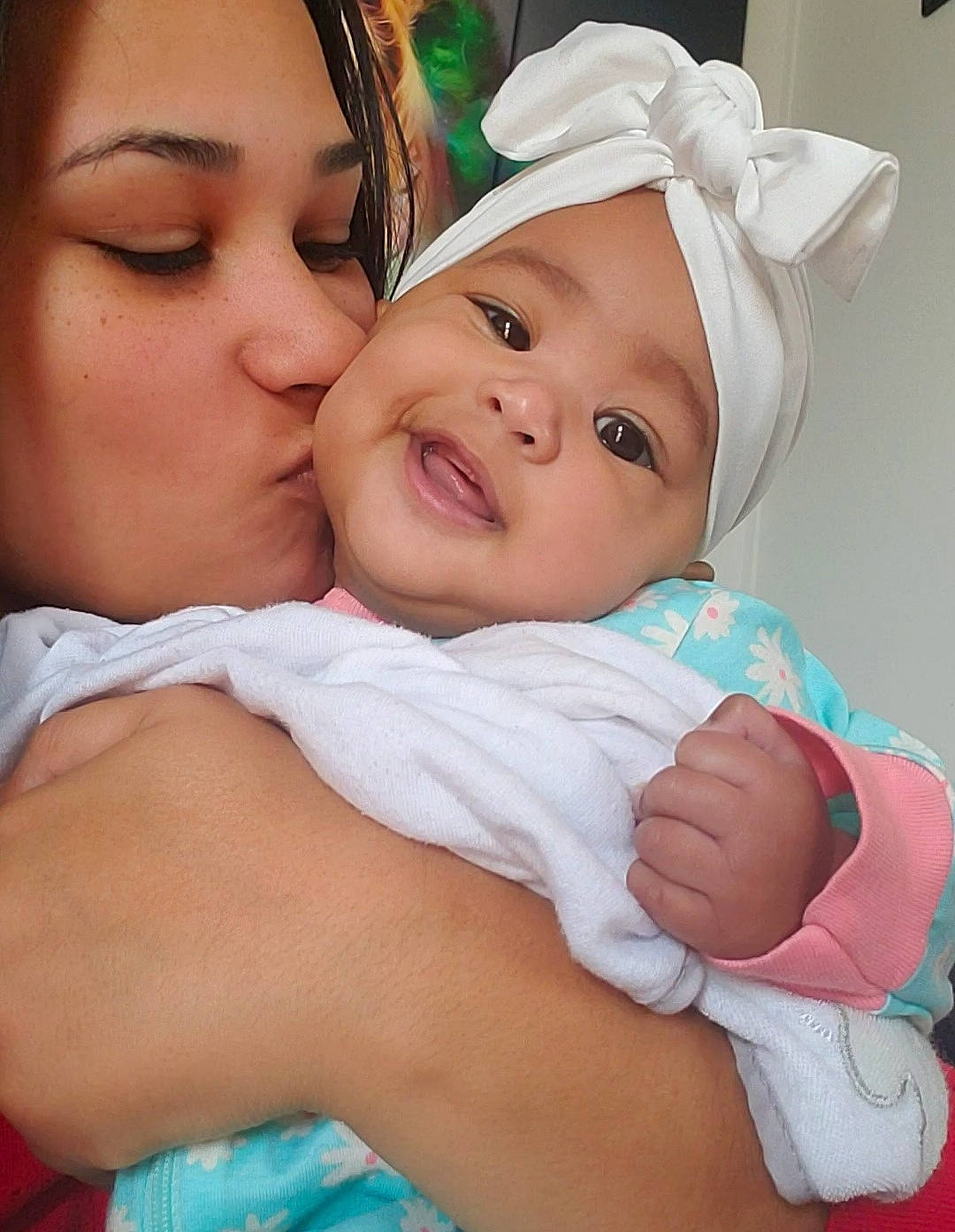 Ocean is registered to the contest to win money with this photo: azure, baby, baby_toddler_clothing, blue, cap, cheek, child, comfort, eye, face, gesture, green, happy, headwear, kiss, lip, mouth, people_in_nature, person, skin