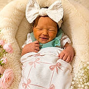 Haisley joined the competition — help win amazing prizes! newborn, baby, smiling, blanket, bow_headband, flowers, pink_bows, cozy, soft, cute, infant, wrapped, resting, peaceful, portrait, closeup, baby_clothing, floral, headwear, sleepy