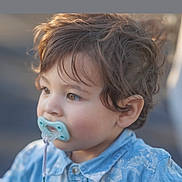 Ivan joined the competition — help win amazing prizes! toddler, child, pacifier, blue_shirt, curly_hair, portrait, side_view, outdoor, young_child, innocence, soft_light, baby, cute, face, expression, casual_clothing, person, daylight, closeup, skin
