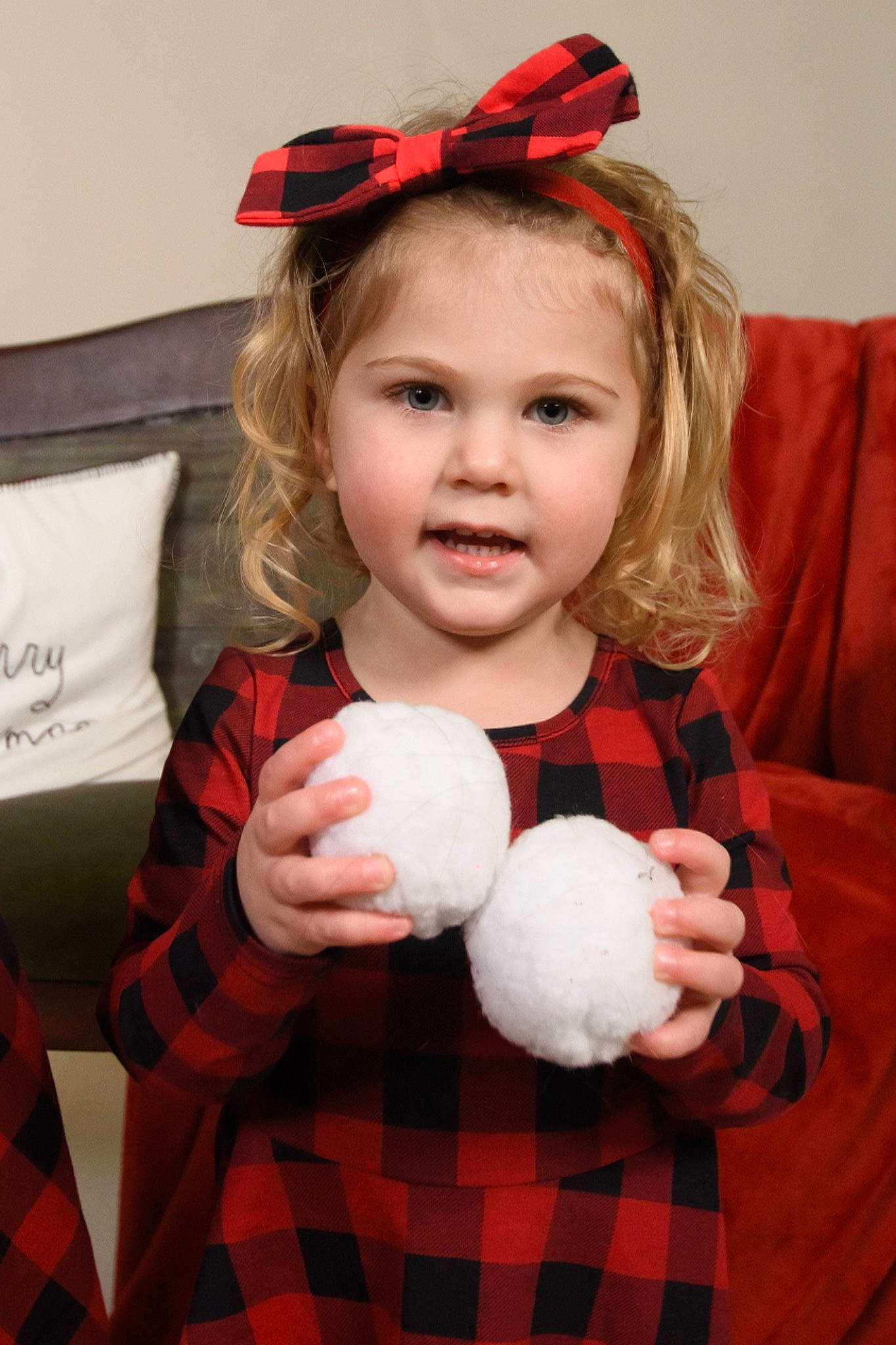 Ayla joined the competition — help win amazing prizes! baby_toddler_clothing, child, costume_accessory, couch, design, eye, hair_accessory, headgear, headpiece, pattern, person, pillow, plaid, plush, red, stuffed_toy, tartan, textile, throw_pillow, toddler