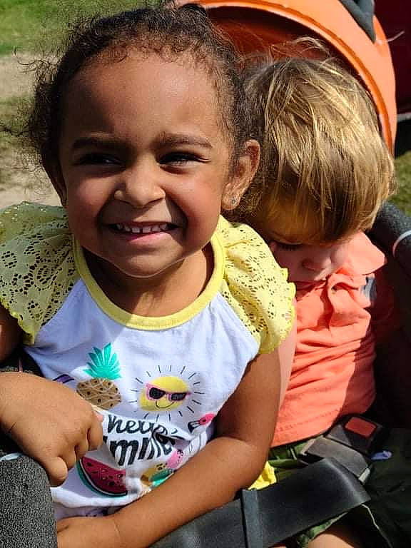 Kaylen is registered to the contest to win money with this photo: child, chin, eye, facial_expression, fun, gesture, grass, hair, hairstyle, happy, head, joy, leisure, organ, people, person, sharing, skin, smile, summer