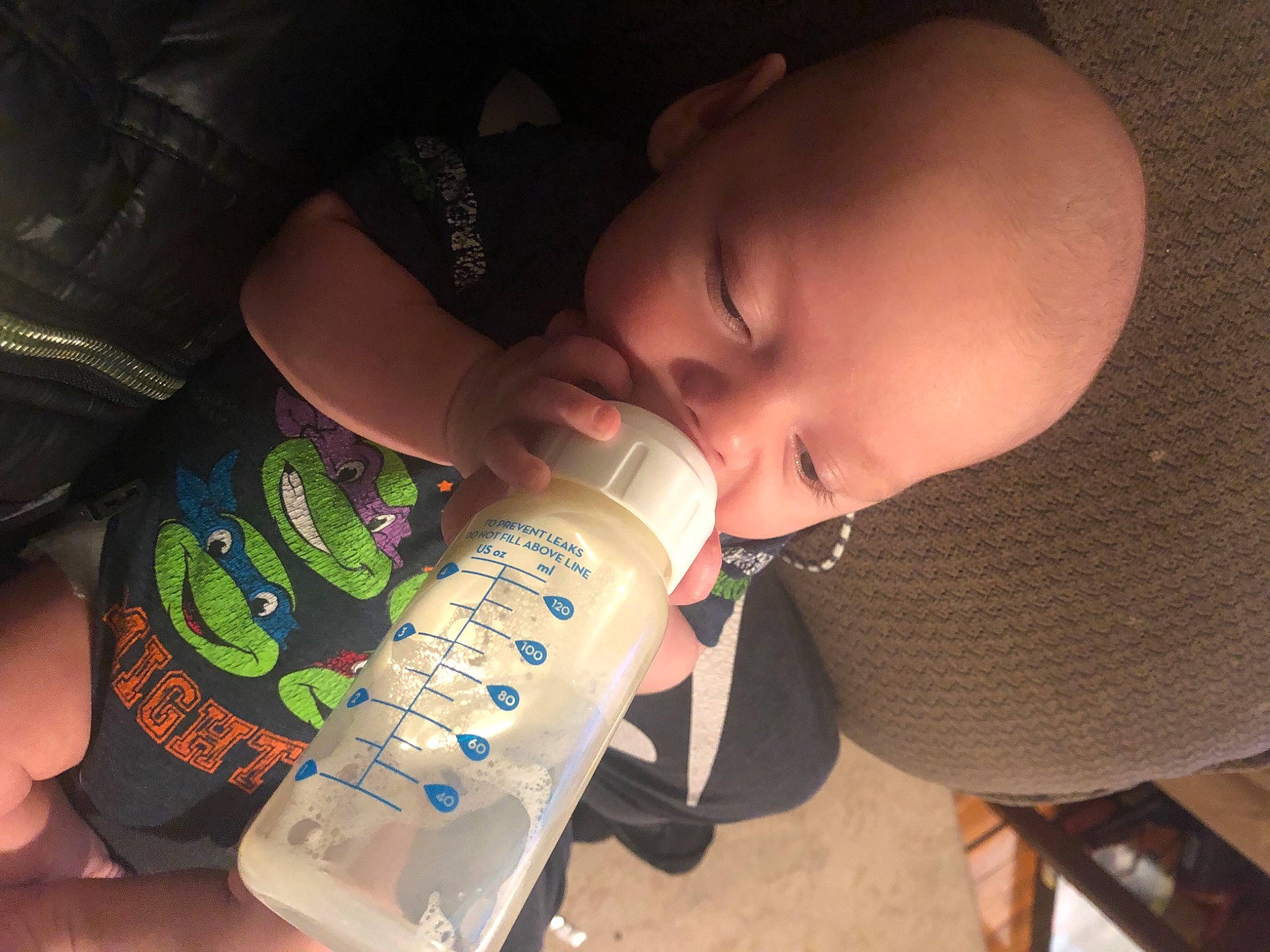 Prescott is registered to the contest to win money with this photo: baby, baby_bottle, baby_products, bottle, cheek, drink, drinking, drinkware, ear, eyelash, finger, human_body, infant_formula, nail, person, plant_milk, plastic_bottle, product, skin, thumb