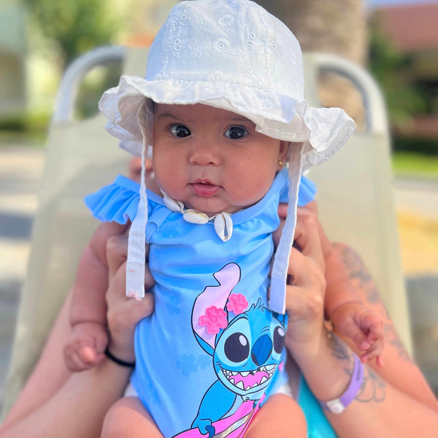 Sophie joined the competition — help win amazing prizes! baby, bikini, bodypart, bonnet, cap, clothing, face, finger, hand, hat, head, person, photography, portrait, sitting, skin, summer, sunhat, swimwear, tattoo