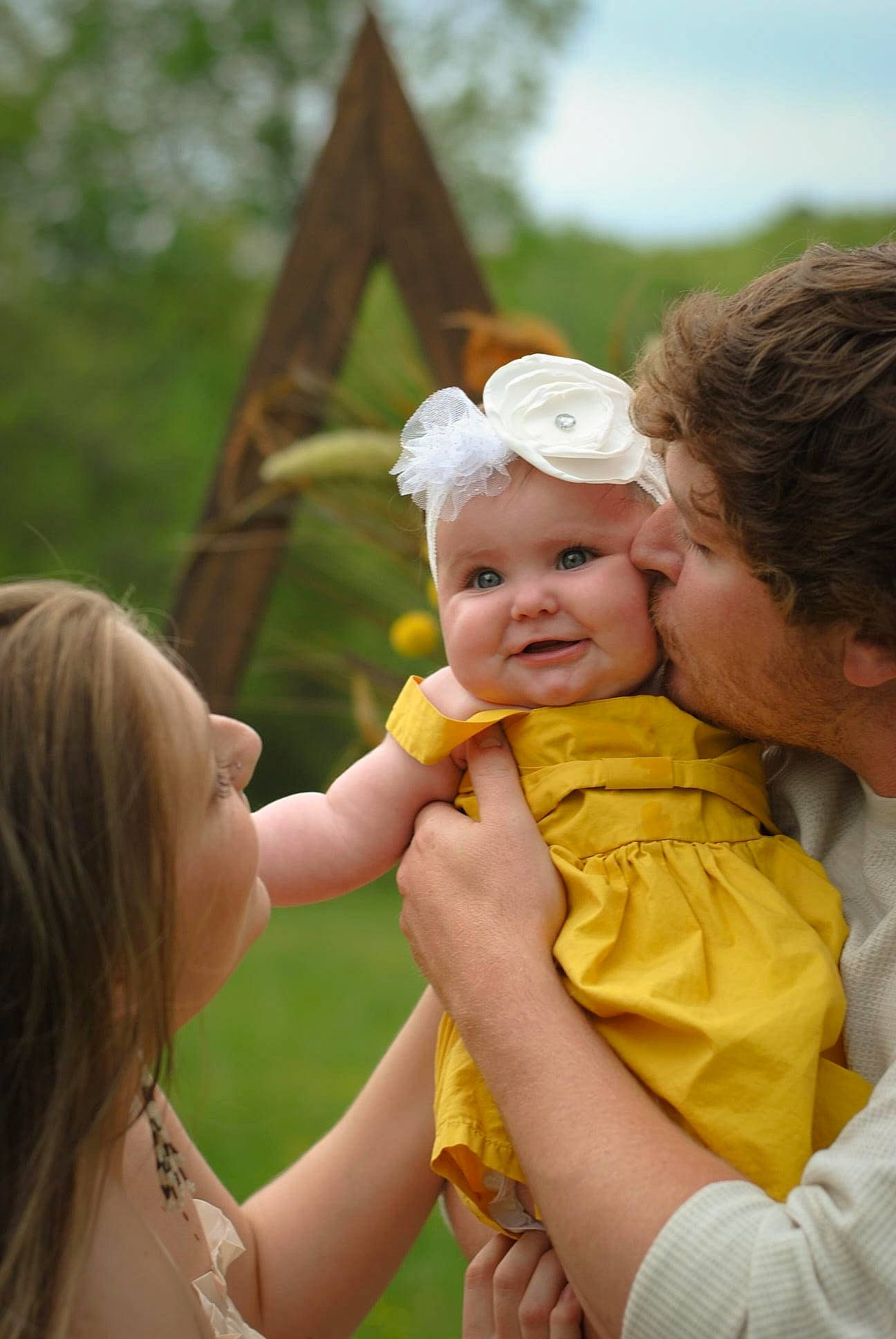 Heidi is registered to the contest to win money with this photo: baby, child, face, fun, gesture, grass, happy, hat, headwear, kiss, leisure, people, people_in_nature, person, photograph, plant, skin, smile, summer, toddler