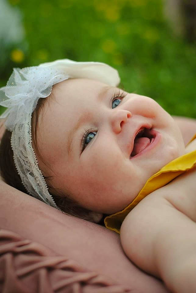 Heidi joined the competition — help win amazing prizes! baby, cheek, child, child_model, close_up, eyelash, face, fashion_accessory, flash_photography, fun, grass, happy, headwear, human_body, lip, people_in_nature, person, portrait_photography, sitting, toddler