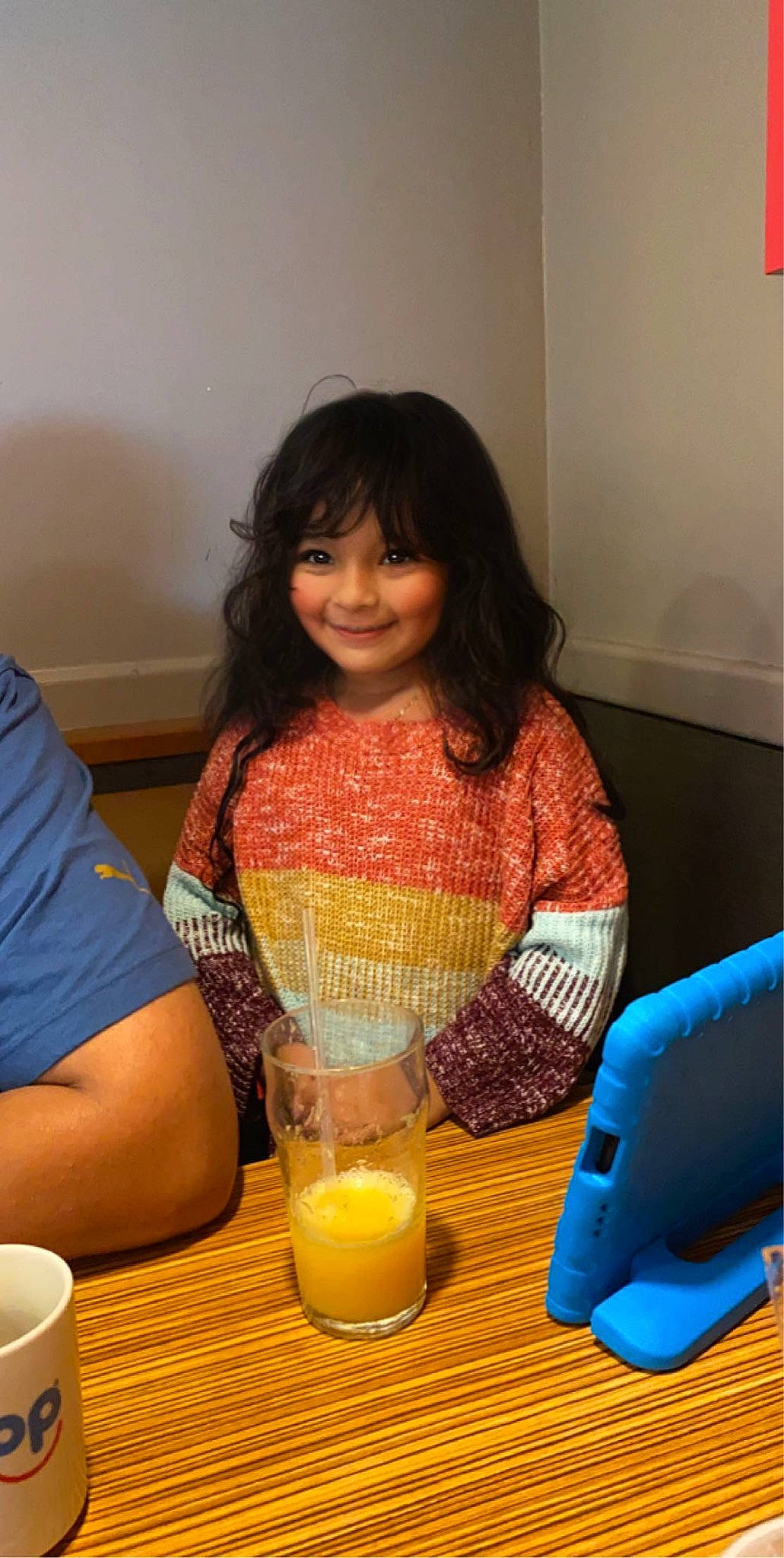 Maggie joined the competition — help win amazing prizes! candle, cup, drink, drinkware, event, fun, happy, household_supply, joy, juice, orange_juice, paper_towel, person, plastic, plastic_bottle, room, serveware, sitting, smile, t_shirt