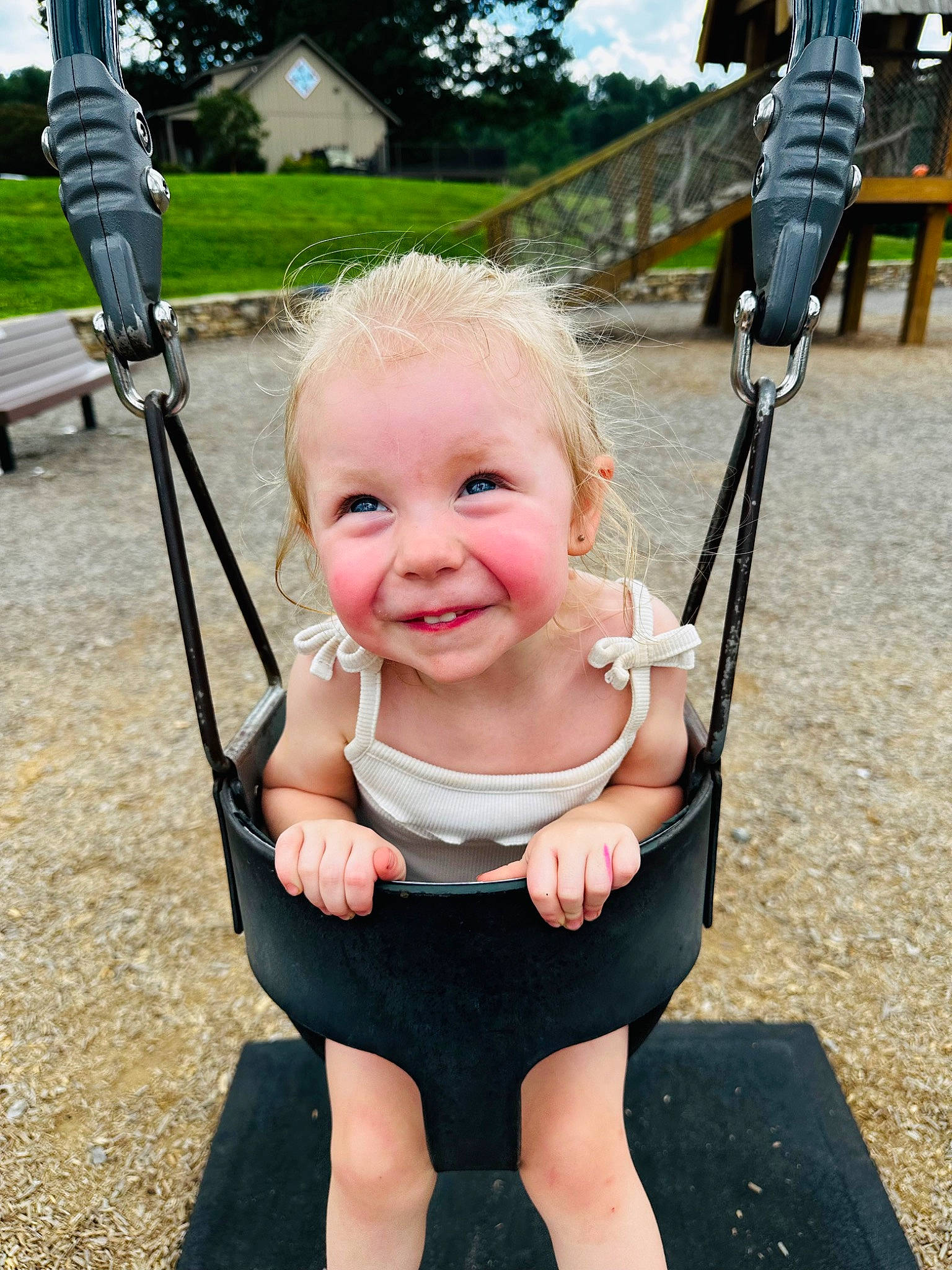 June is registered to the contest to win money with this photo: baby, black, cheek, dress, finger, gesture, grass, green, happy, joy, leisure, person, plant, playground, product, recreation, smile, summer, swing, toddler