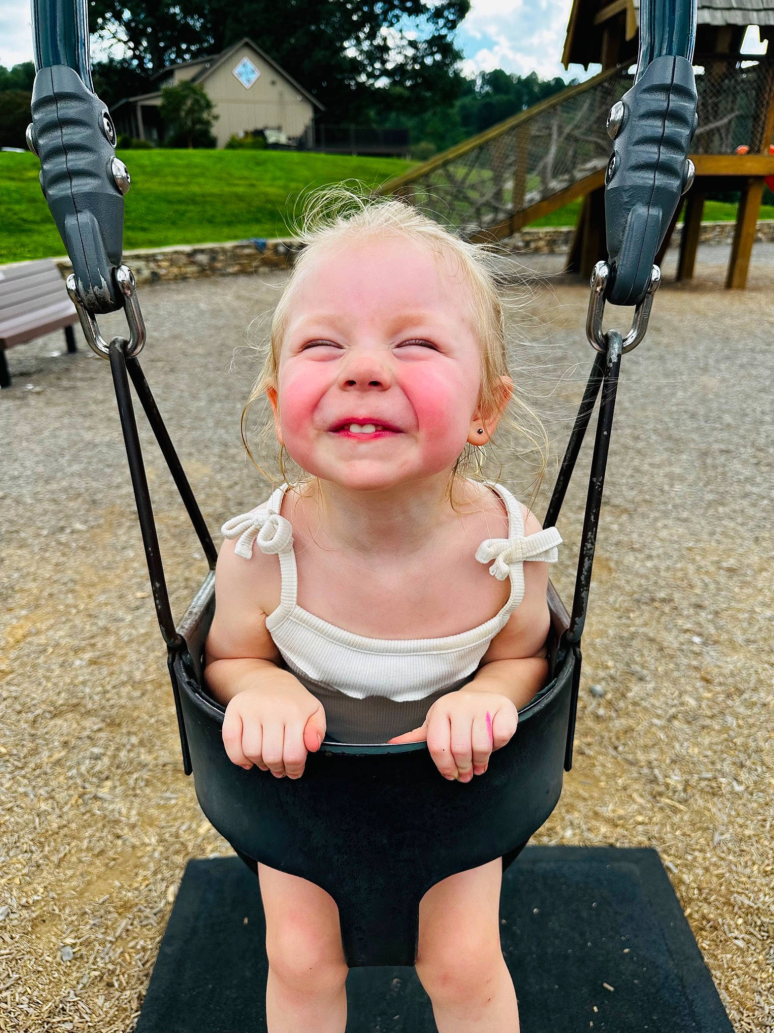 June is registered to the contest to win money with this photo: baby, baby_toddler_clothing, beauty, eye, finger, fun, grass, happy, joy, leisure, people, person, pink, plant, product, recreation, smile, standing, summer, swing