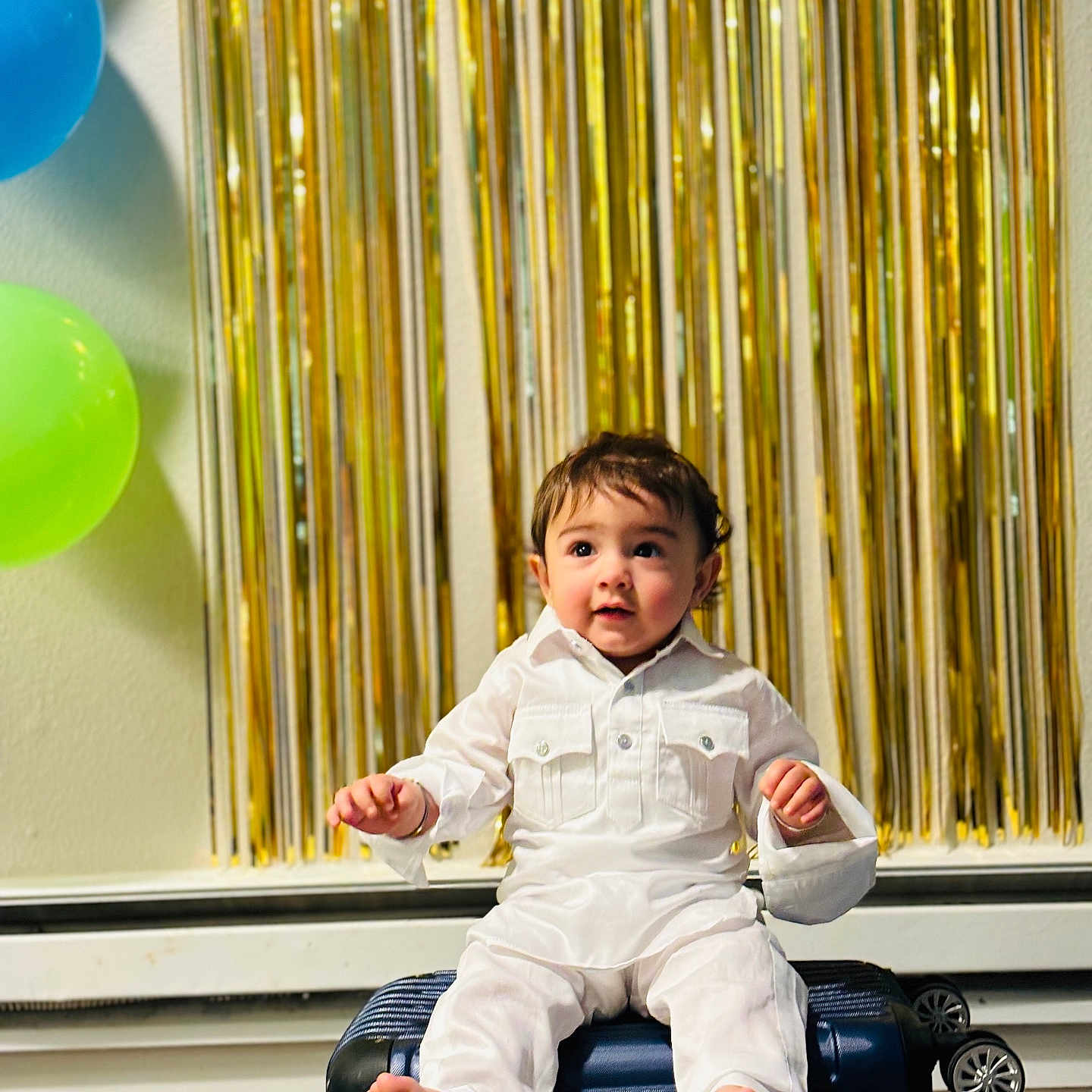 Aviraj joined the competition — help win amazing prizes! baby, balloon, bodypart, clothing, coat, dress, face, finger, footwear, formalwear, furniture, hand, head, machine, pants, person, photography, portrait, sitting, wheel