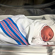 Dalton joined the competition — help win amazing prizes! newborn, baby, swaddled, hospital, blanket, bassinet, sleeping, infant, hat, bed, resting, peaceful, small, wrapped, portrait, cute, child, person, healthcare, nursery