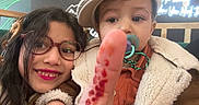 Joulene participe au concours pour gagner de l'argent avec cette photo : child, children, smiling, glasses, pacifier, hat, finger, red_spots, coat, jacket, indoor, portrait, cute, happy, sibling, closeup, face, person, warm_clothing, playful