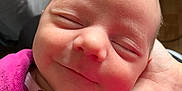 Emma participe au concours pour gagner de l'argent avec cette photo : baby, newborn, smiling, face, closeup, sleeping, hand, clothing, purple, soft, cute, infant, peaceful, portrait, resting, human, child, warm, toddler, zipped_jacket