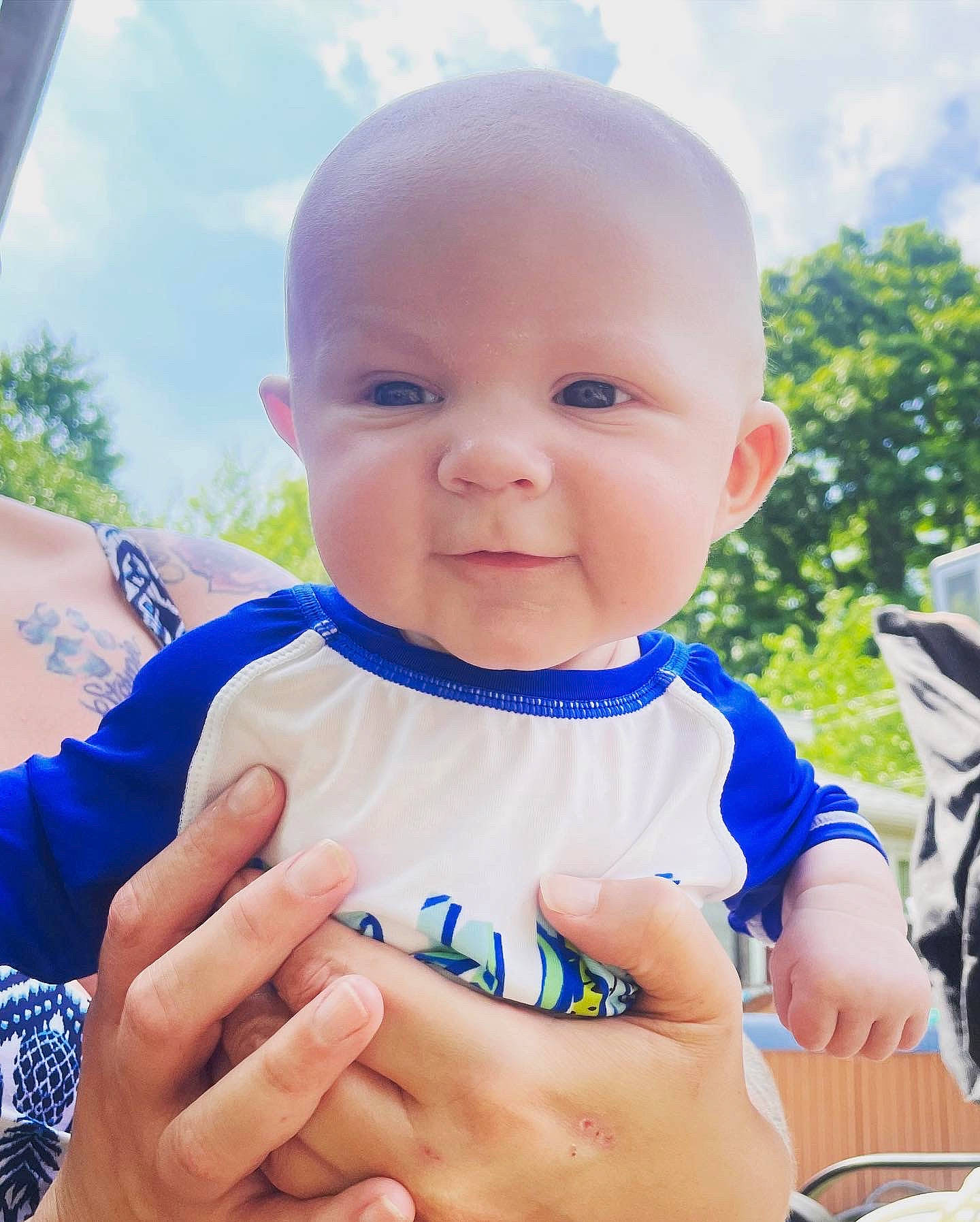 Grayson joined the competition — help win amazing prizes! azure, baby, baby_toddler_clothing, chin, cloud, finger, gesture, grass, happy, iris, leisure, people, people_in_nature, person, skin, sky, sleeve, smile, t_shirt, tableware
